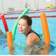 Child having fun with pool noodles in the swimming pool