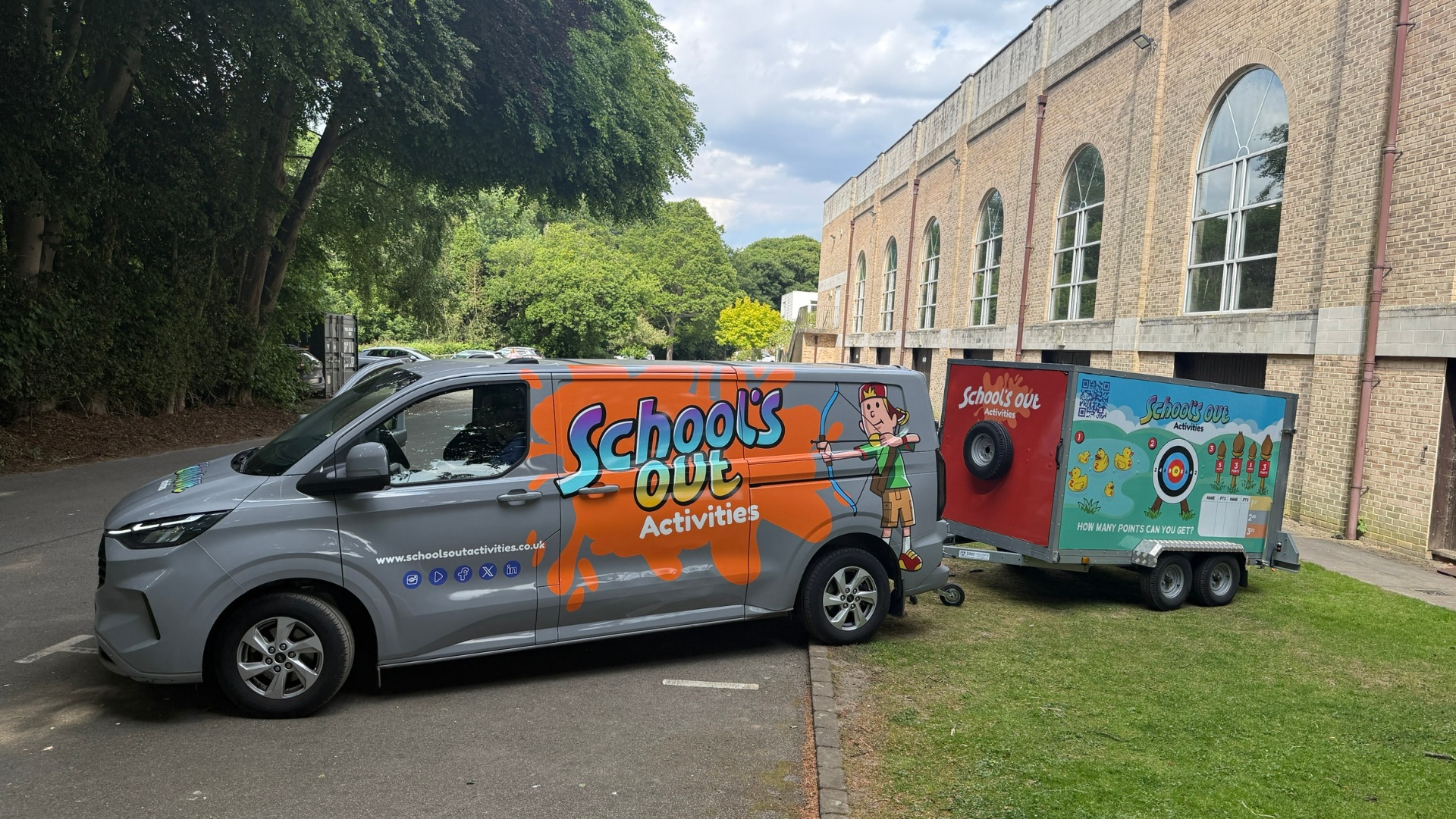 School's Out branded Transit van with games trailer