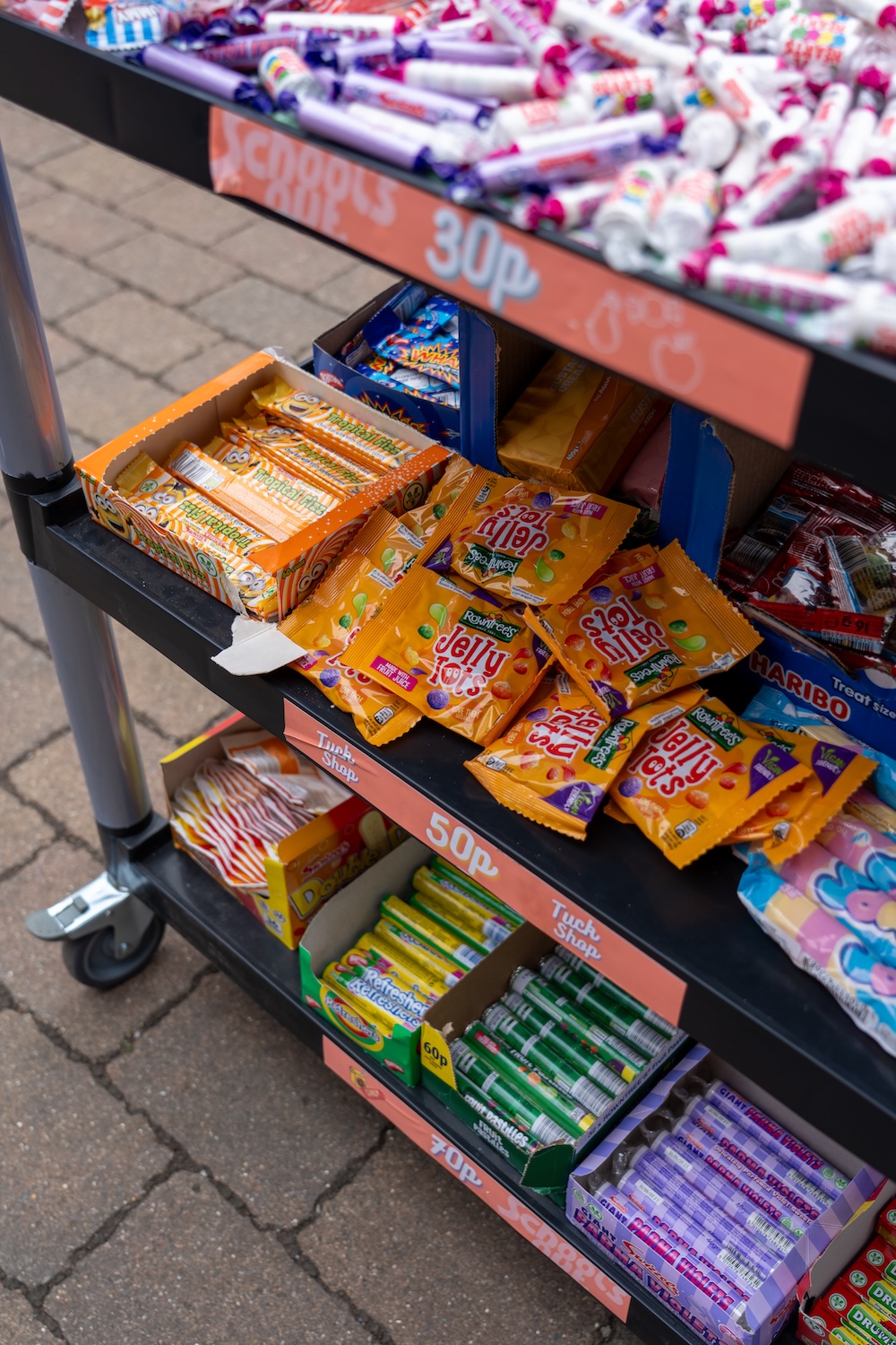 Our tuck shop trolley with three shelves of confectionery items